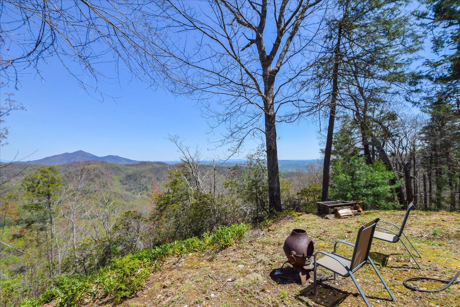 380 Hemlock Ridge Road Southeast Copper Hill, VA 24079 - Photo 47 of 59 a view of a backyard with table and chairs under an umbrella