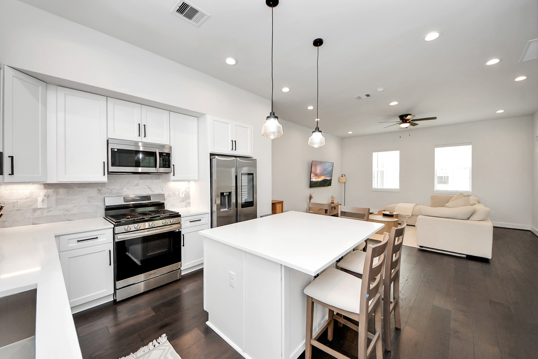 5502 Wheatley Street, Unit B Houston, TX 77091 - Photo 11 of 35 a open kitchen with stainless steel appliances granite countertop a stove sink refrigerator and microwave