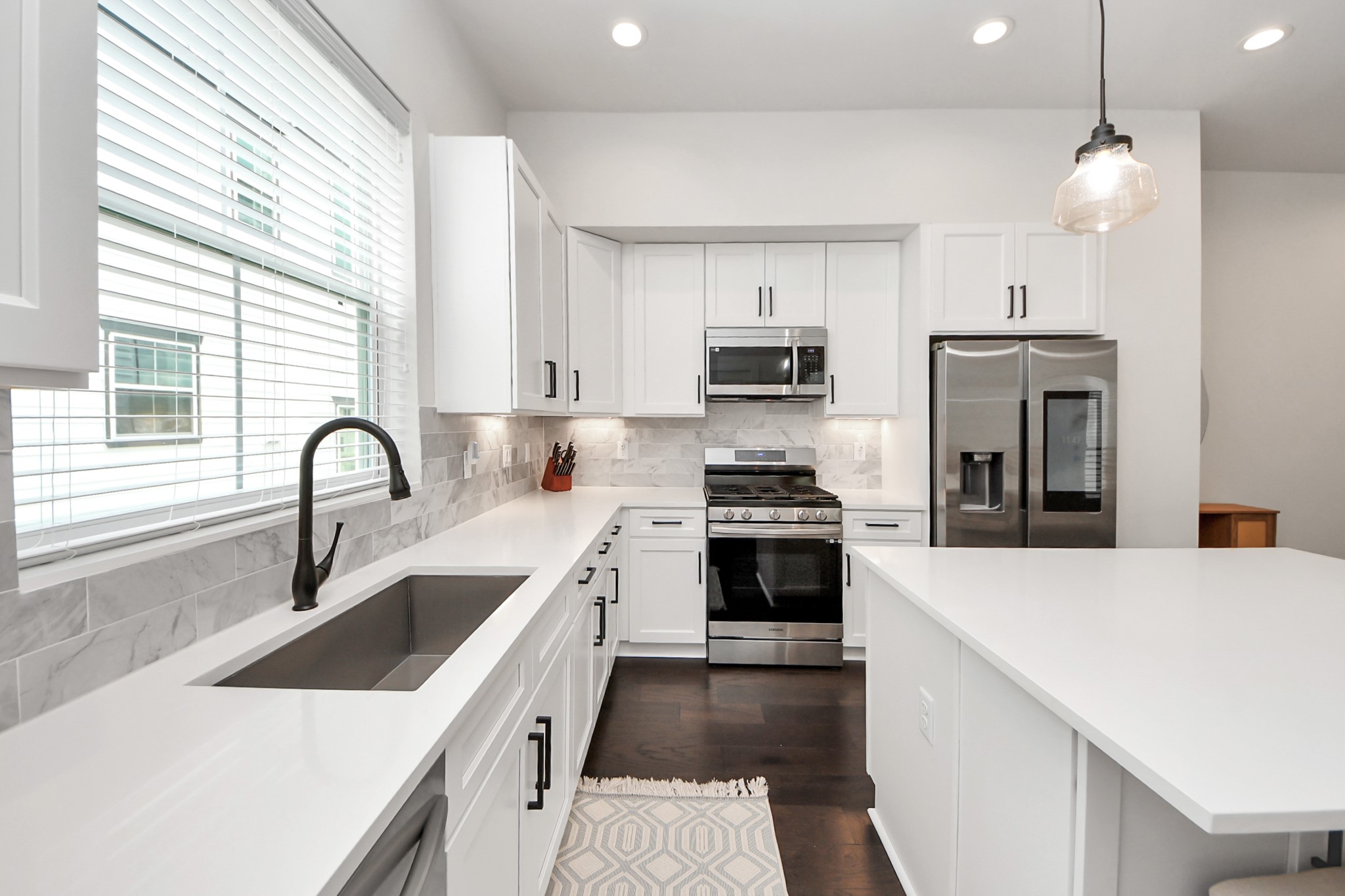 5502 Wheatley Street, Unit B Houston, TX 77091 - Photo 12 of 35 a kitchen with a sink a stove and cabinets