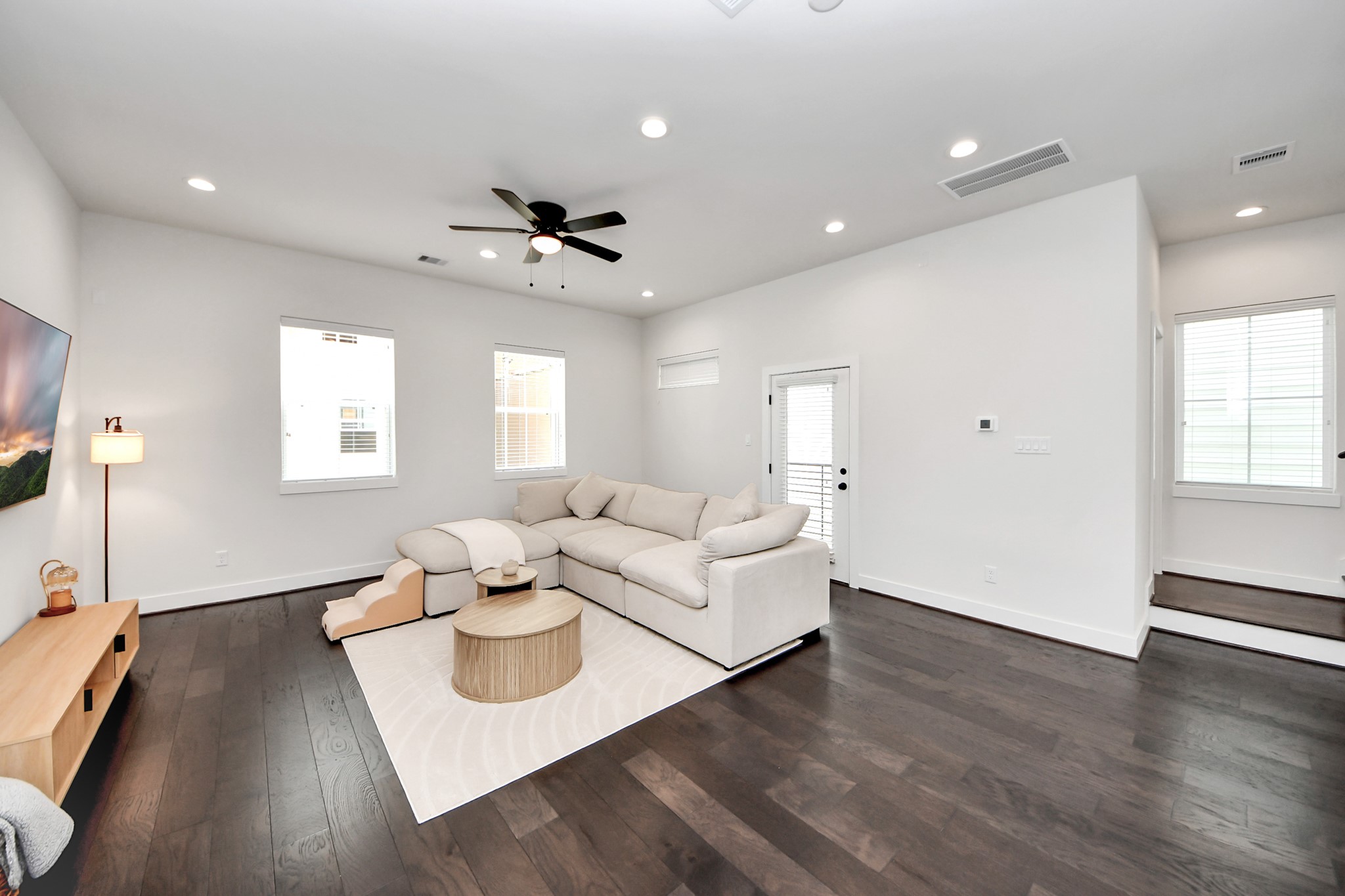 5502 Wheatley Street, Unit B Houston, TX 77091 - Photo 14 of 35 a living room with couches and kitchen view with wooden floor