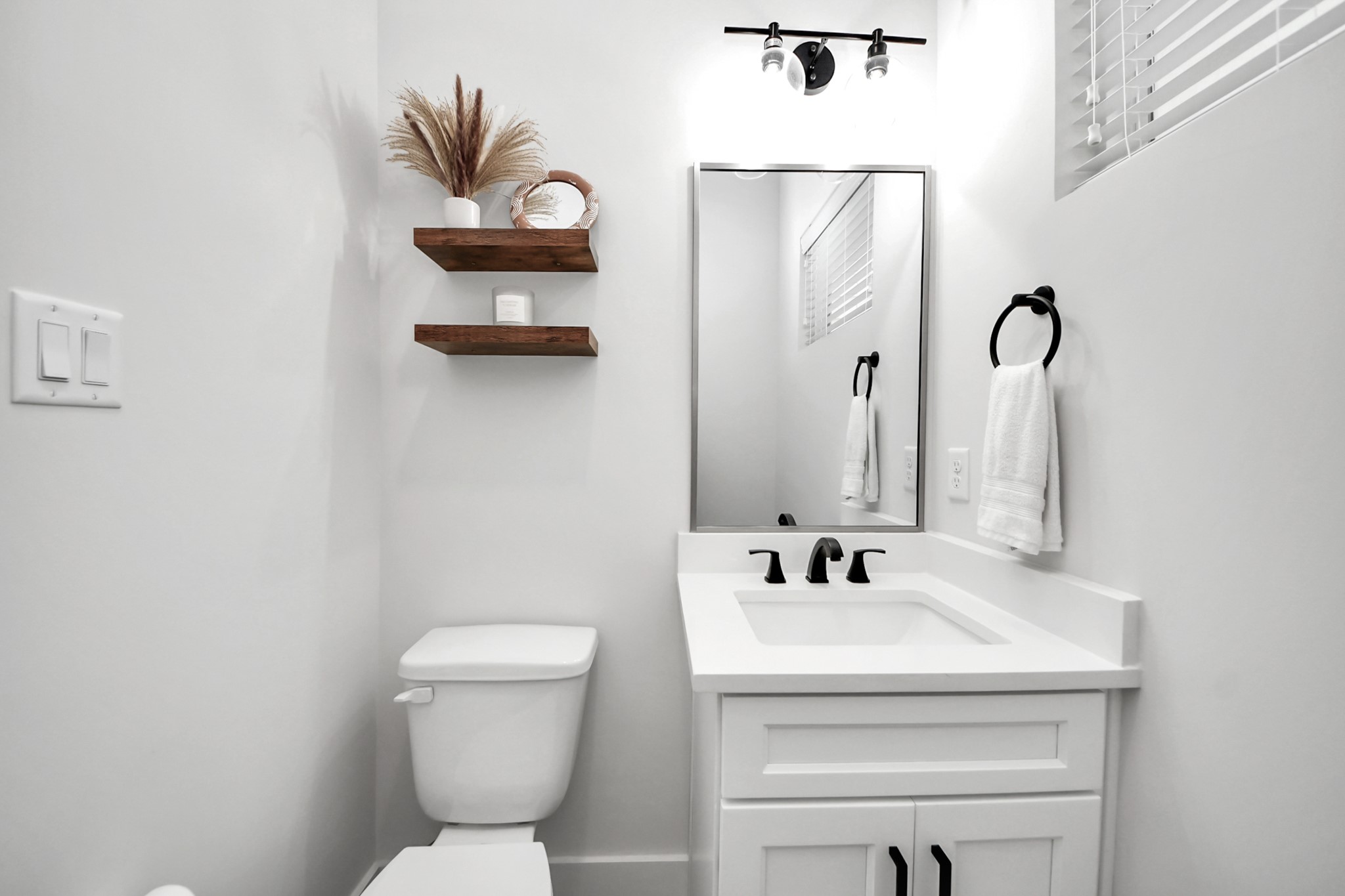 5502 Wheatley Street, Unit B Houston, TX 77091 - Photo 17 of 35 a bathroom with a toilet a sink and a mirror