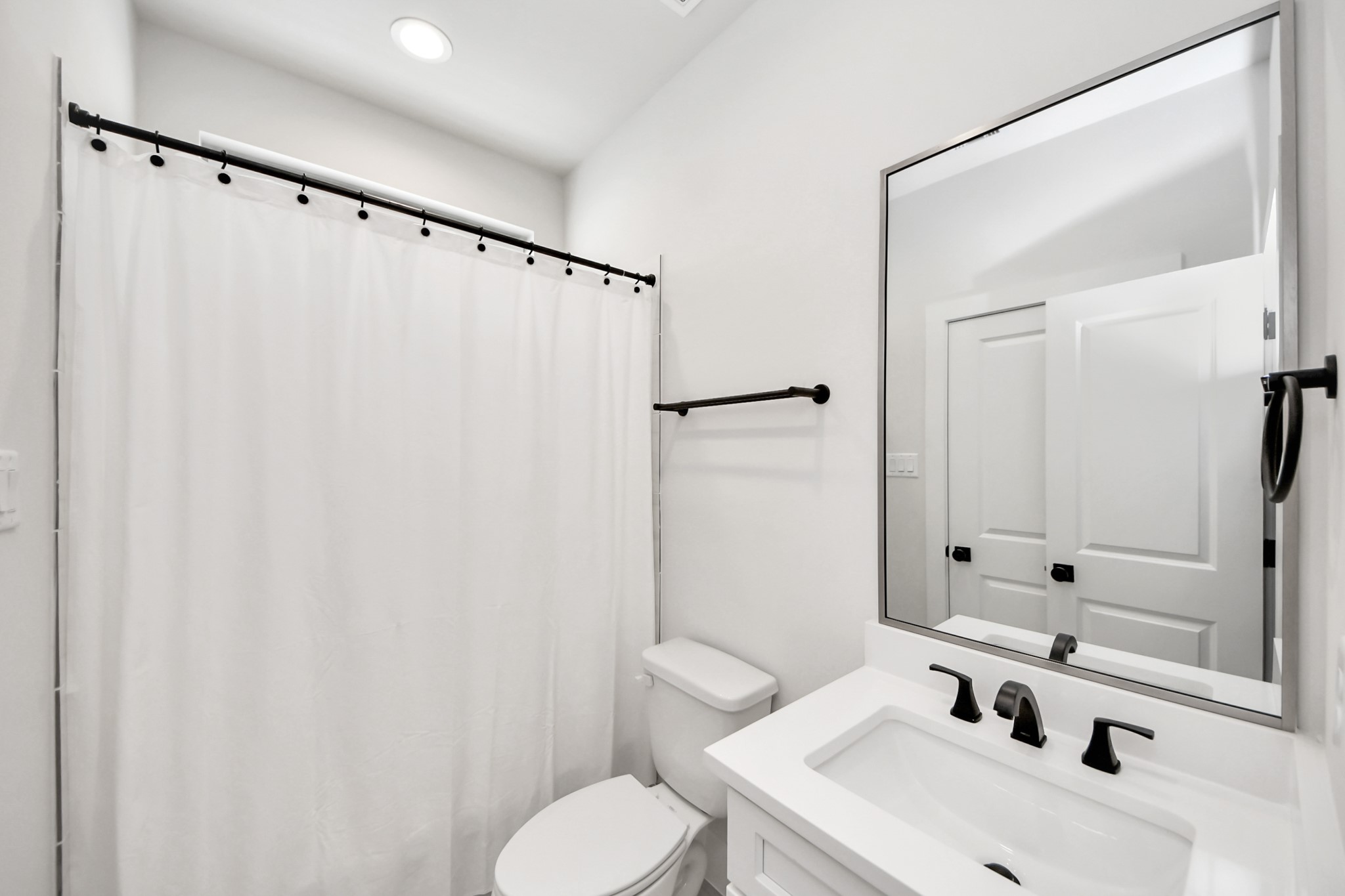 5502 Wheatley Street, Unit B Houston, TX 77091 - Photo 18 of 35 a bathroom with a sink mirror and toilet