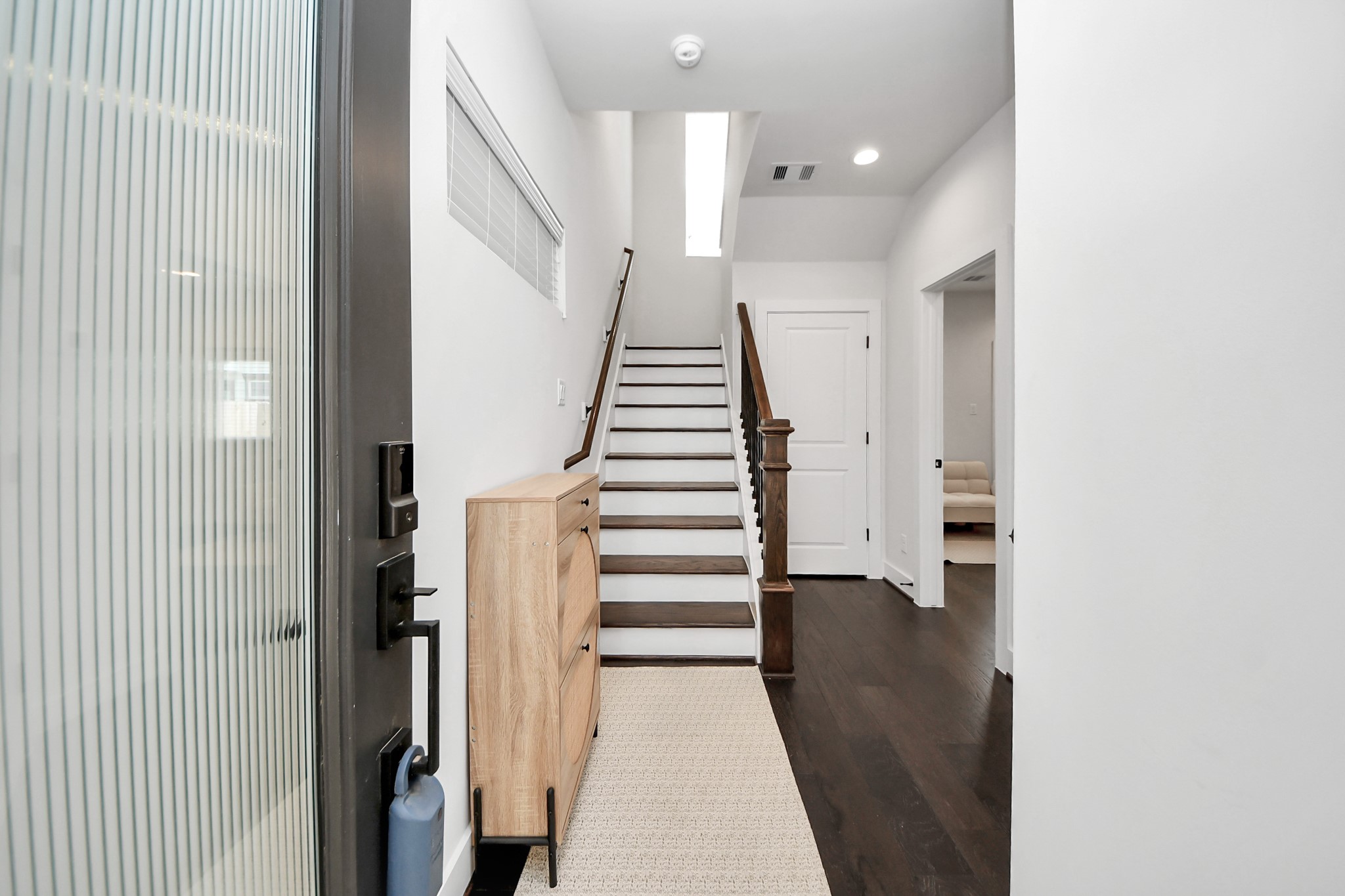 5502 Wheatley Street, Unit B Houston, TX 77091 - Photo 2 of 35 a view of a hallway with stairs and wooden floor