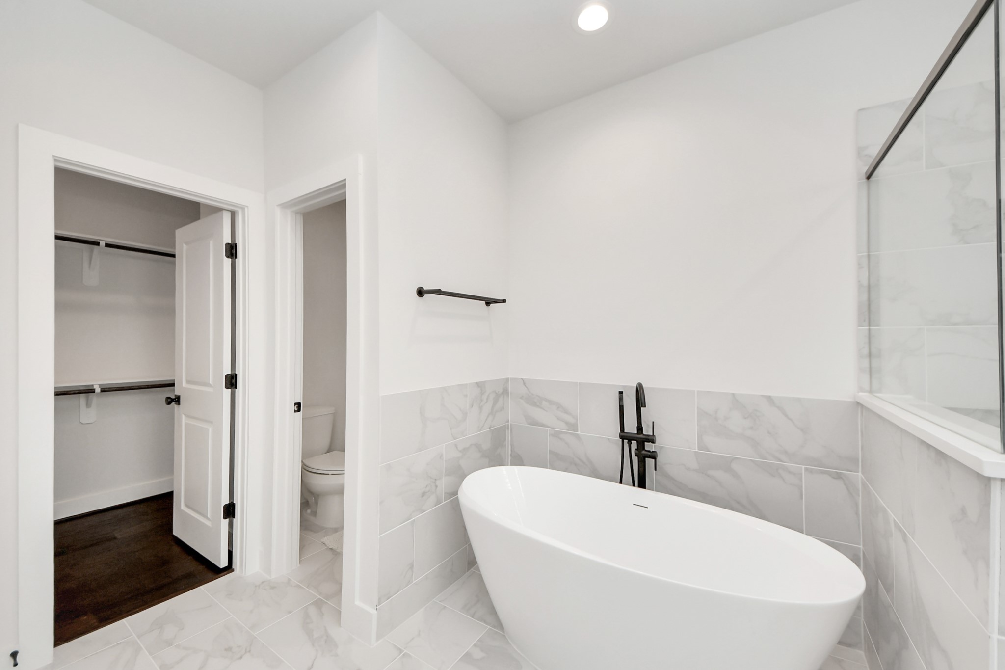 5502 Wheatley Street, Unit B Houston, TX 77091 - Photo 28 of 35 a white bath tub sitting in a bathroom