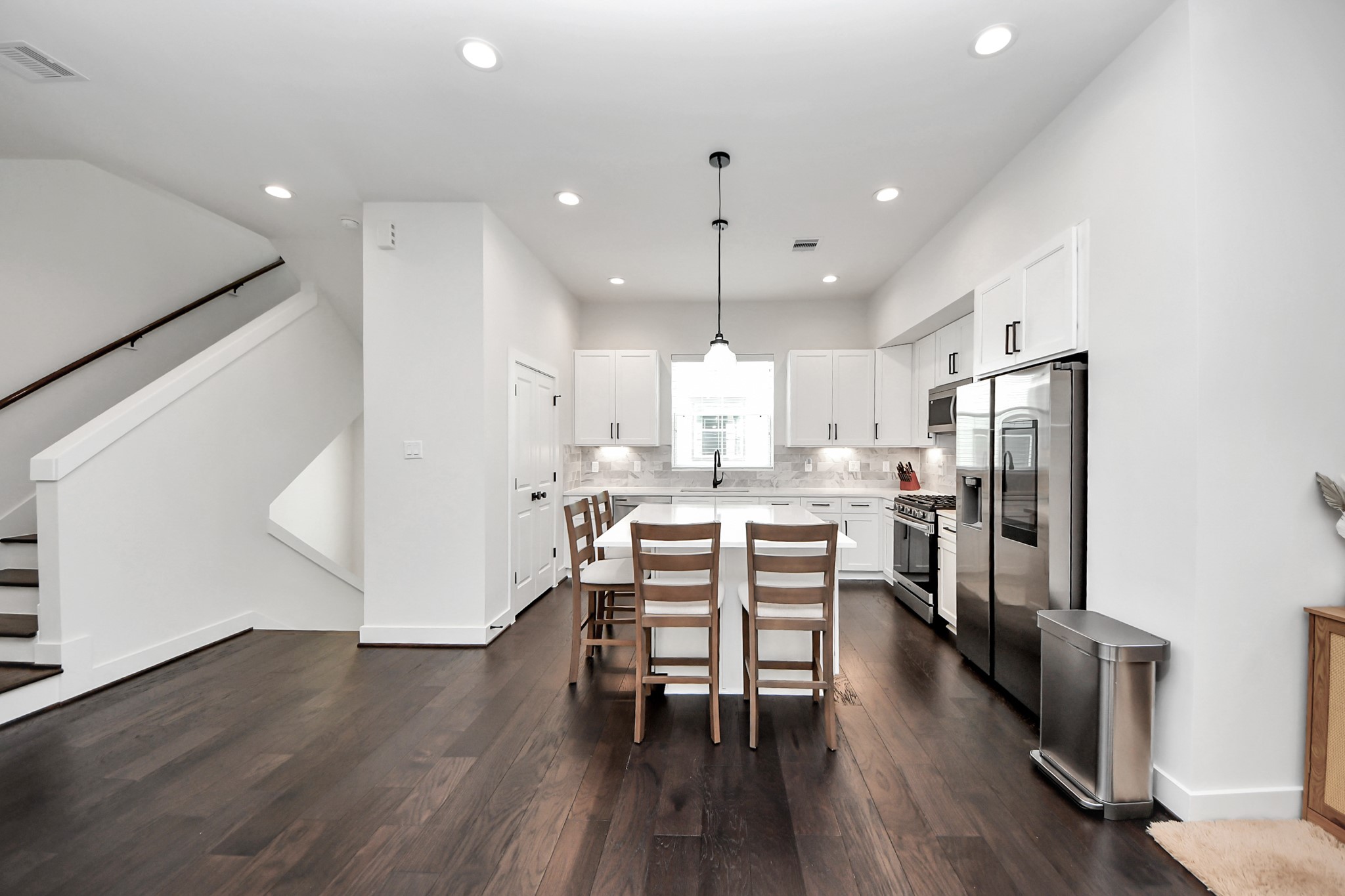 5502 Wheatley Street, Unit B Houston, TX 77091 - Photo 7 of 35 an open kitchen with wooden floor and stainless steel appliances