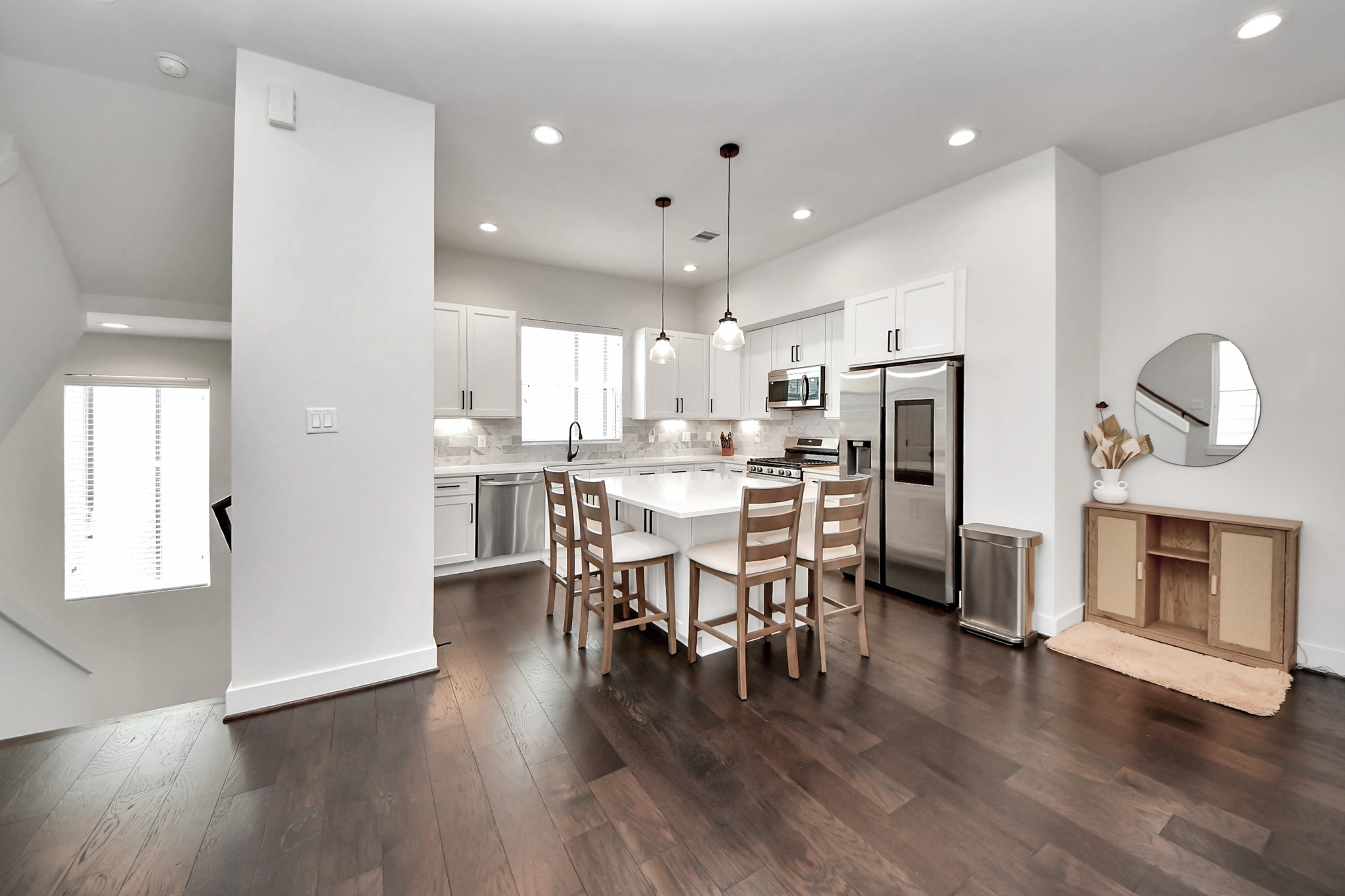 5502 Wheatley Street, Unit B Houston, TX 77091 - Photo 8 of 35 an open kitchen with wooden floor and stainless steel appliances