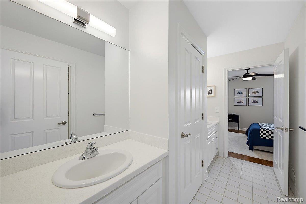 1422 Galena Rochester, MI 48306 - Photo 44 of 73 Bathroom vanity featuring a rectangular undermount sink, a chrome faucet, and a large wall-mounted mirror