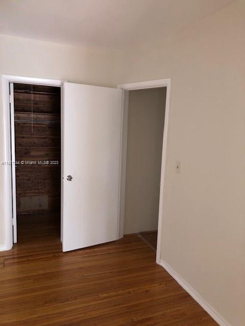 701 Southwest 20th Road, Unit A Miami, FL 33129 - Photo 3 of 4 a view of an empty room with wooden floor and closet