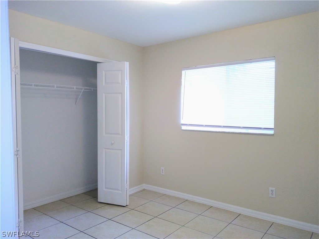 2213 Wilson Road Lehigh Acres, FL 33973 - Photo 8 of 14 a view of an empty room with window