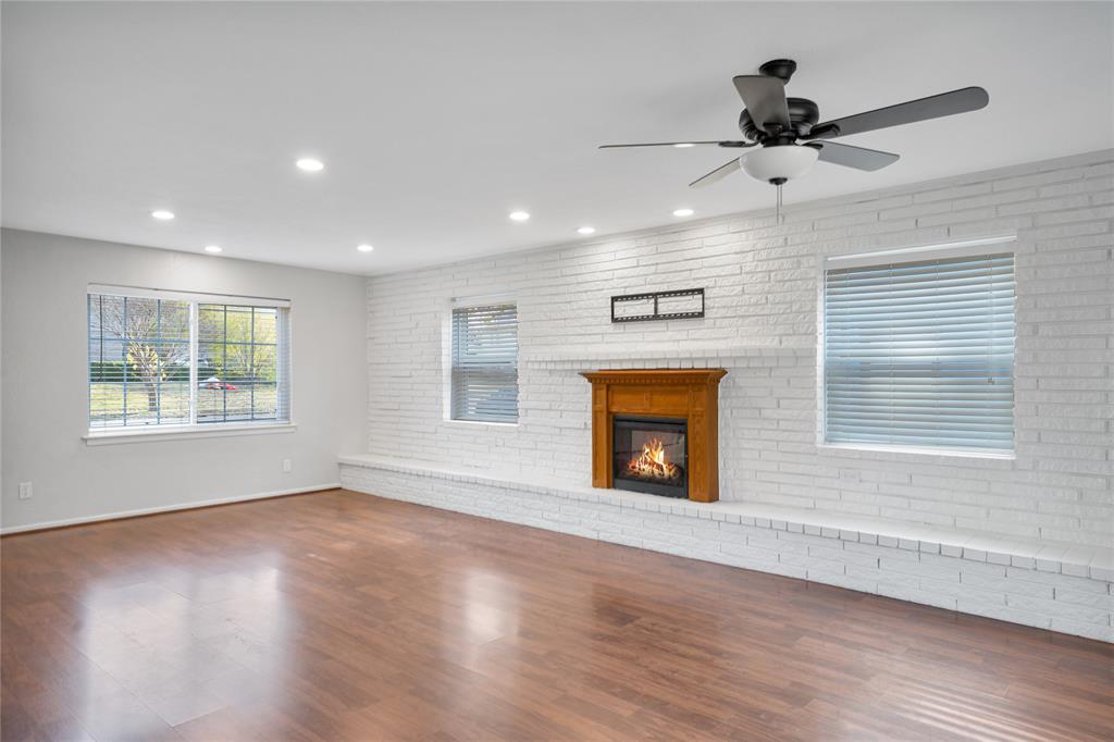 9227 Pinewood Drive Dallas, TX 75243 - Photo 6 of 27 a view of an empty room with a window and wooden floor