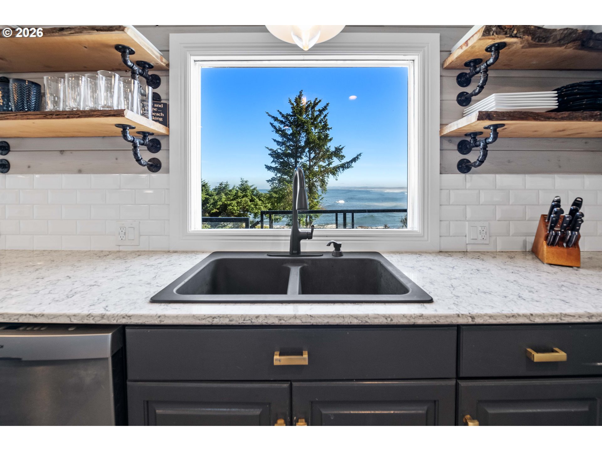 3232 Sunset Boulevard Seaside, OR 97138 - Photo 10 of 48 a kitchen sink with granite countertop a sink and cabinets