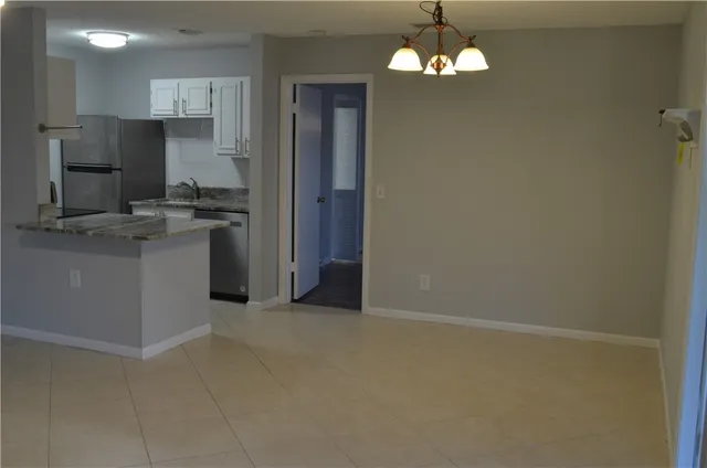 a kitchen with stainless steel appliances granite countertop a refrigerator and a stove