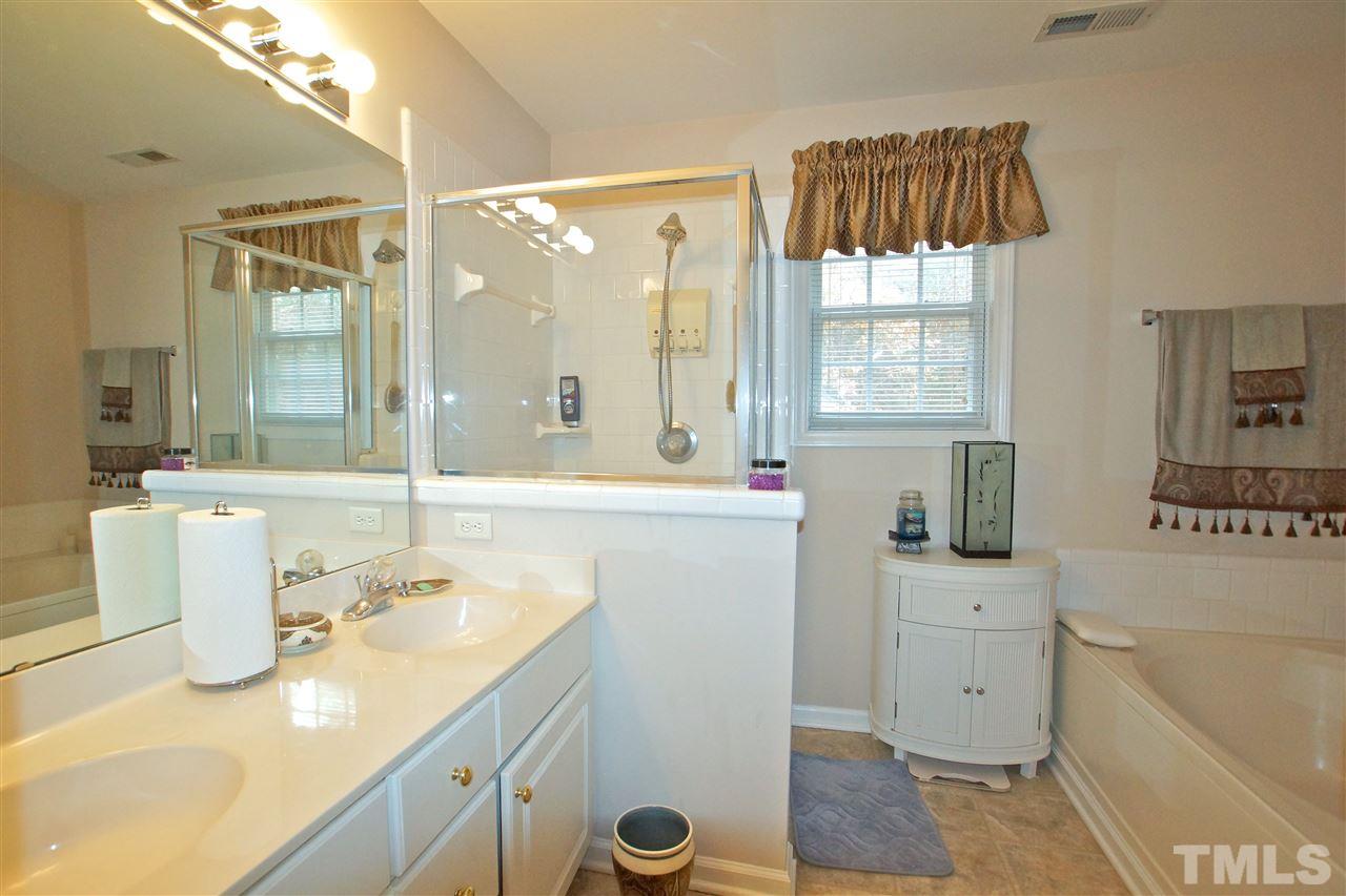 724 Windcrest Road Durham, NC 27713 - Photo 16 of 24 Large master bath with double sink, glass shower and a garden tub to enjoy after a long day of work.