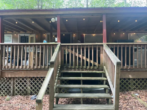 a view of a small house with a door and a large window