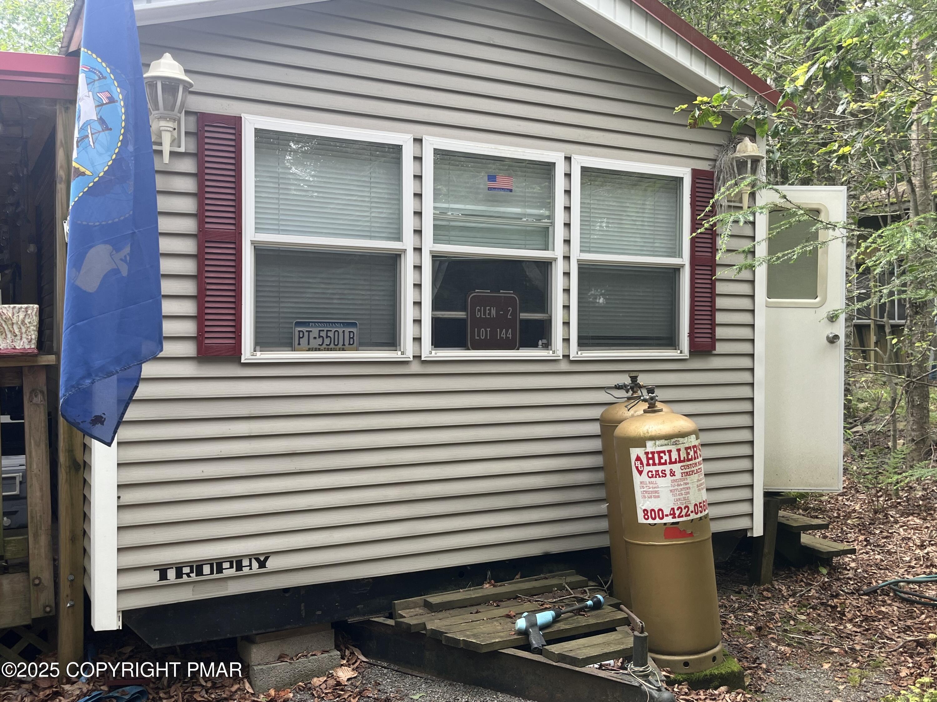 19 Menoken Trail Newfoundland, PA 18445 - Photo 3 of 12 a view of a small house with a door and a large window