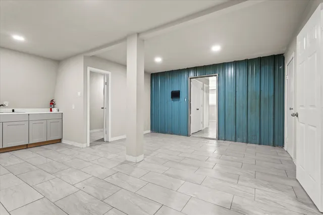 a view of an empty room with a bathroom