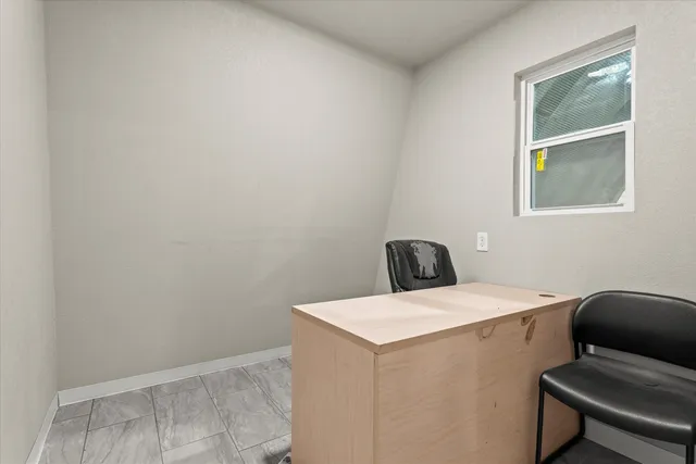 a white toilet sitting next to a white sink and vanity
