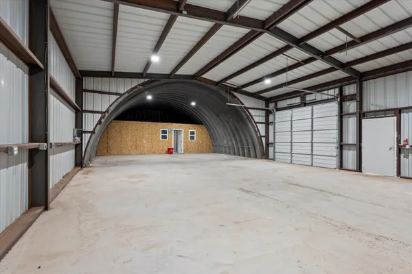 a view of a dirt road and a building
