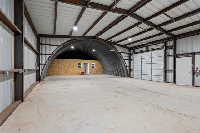 a view of a dirt road and a building