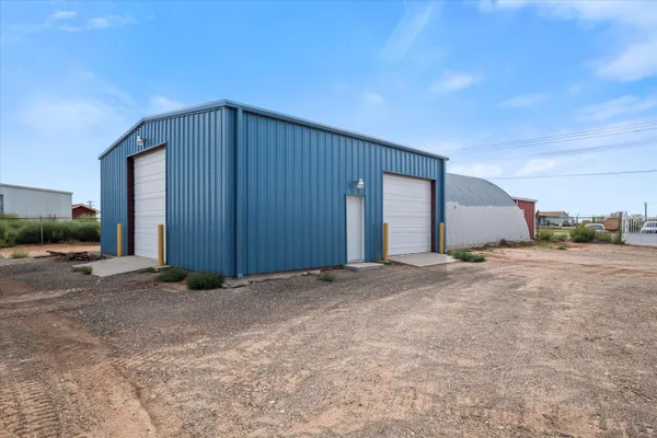 a view of a house with backyard and parking