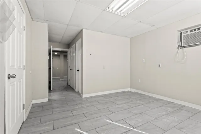 a view of a hallway with wooden shelves
