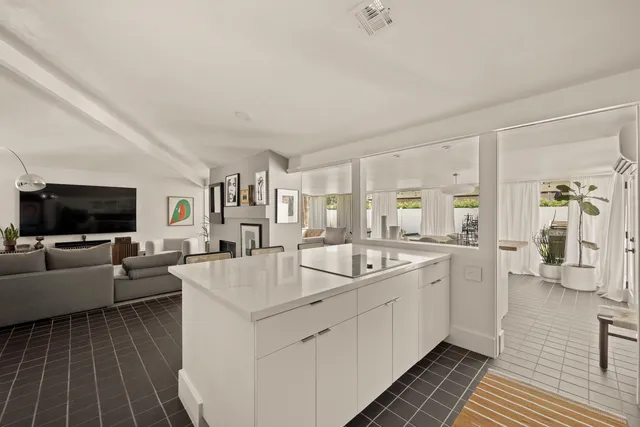 a view of a patio with table and chairs and potted plants