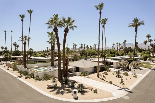 a kitchen with stainless steel appliances kitchen island granite countertop a refrigerator and a stove top oven