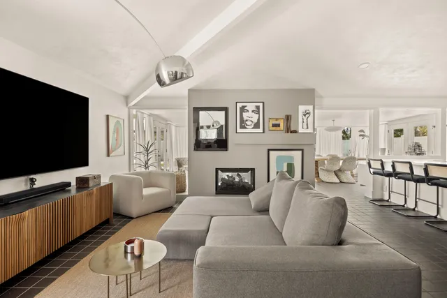 a living room with furniture and a floor to ceiling window