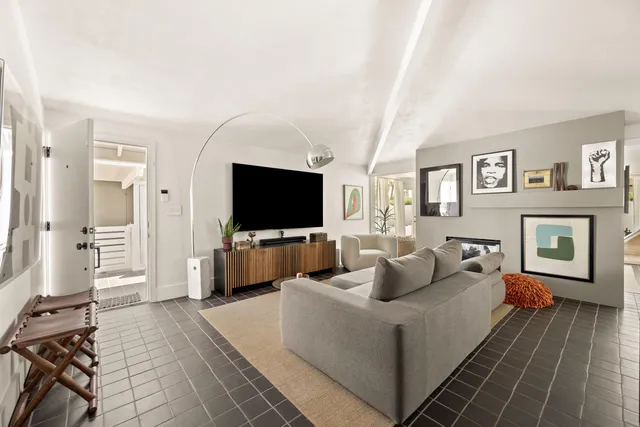 a living room with furniture fireplace and a flat screen tv