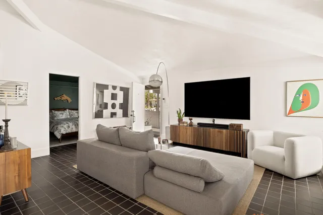 a view of a swimming pool with a yard and sitting area