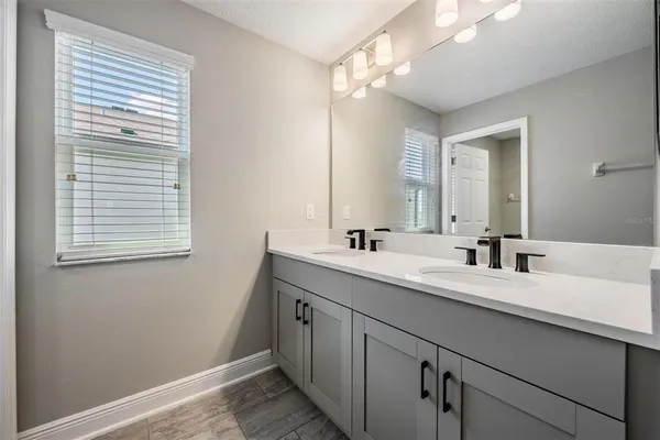 a spacious bedroom with a bed and a flat screen tv