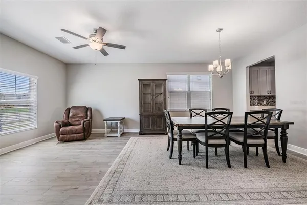 a view of a dining room with furniture and chandelier