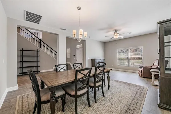 a view of a dining room with furniture and wooden floor