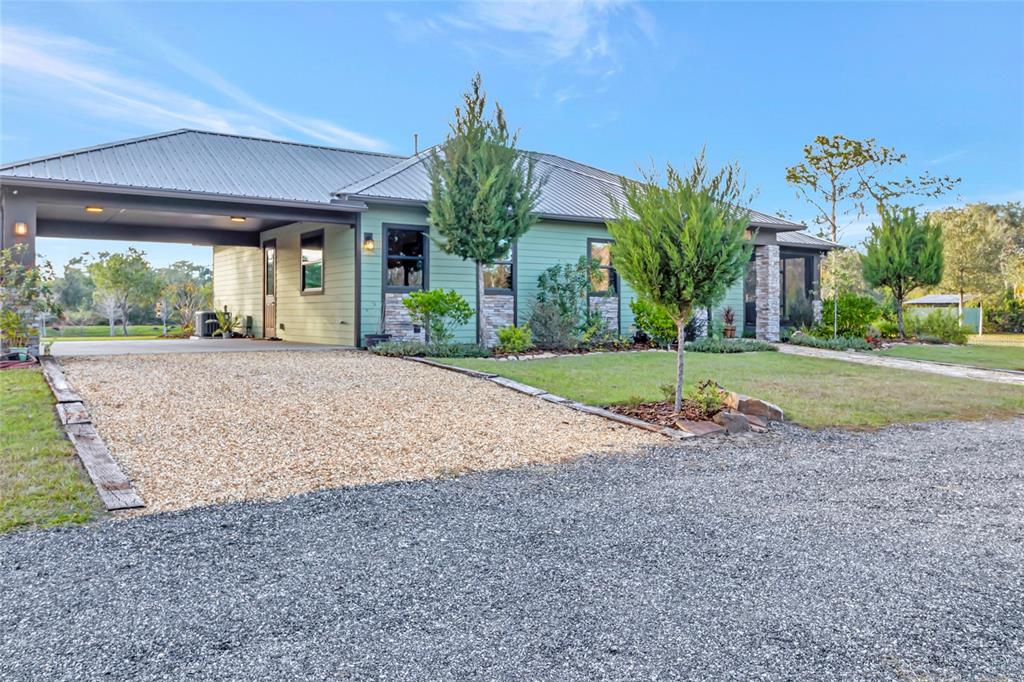 7330 Crabgrass Road St. Cloud, FL 34773 - Photo 56 of 60 a view of a house with a yard and plant