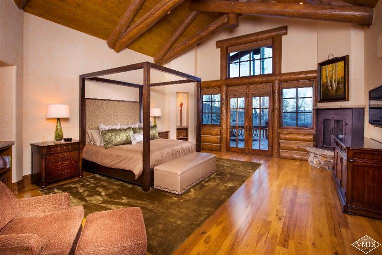 1888 Daybreak Ridge Road Avon, CO 81620 - Photo 13 of 25 a spacious bedroom with a large bed and a balcony