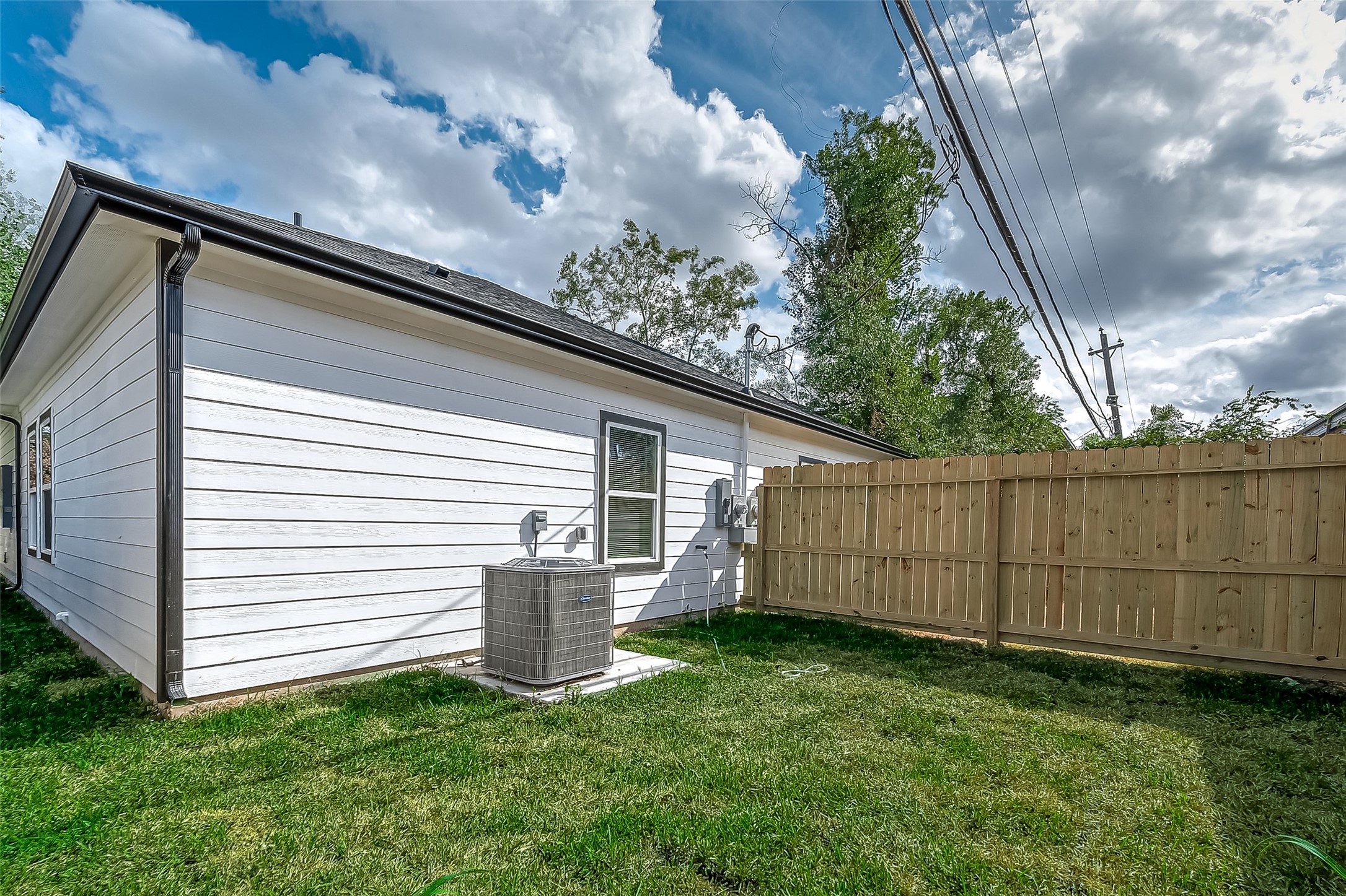 7234 St Augustine Street, Unit A Houston, TX 77021 - Photo 19 of 20 a view of a backyard with plants and a large tree