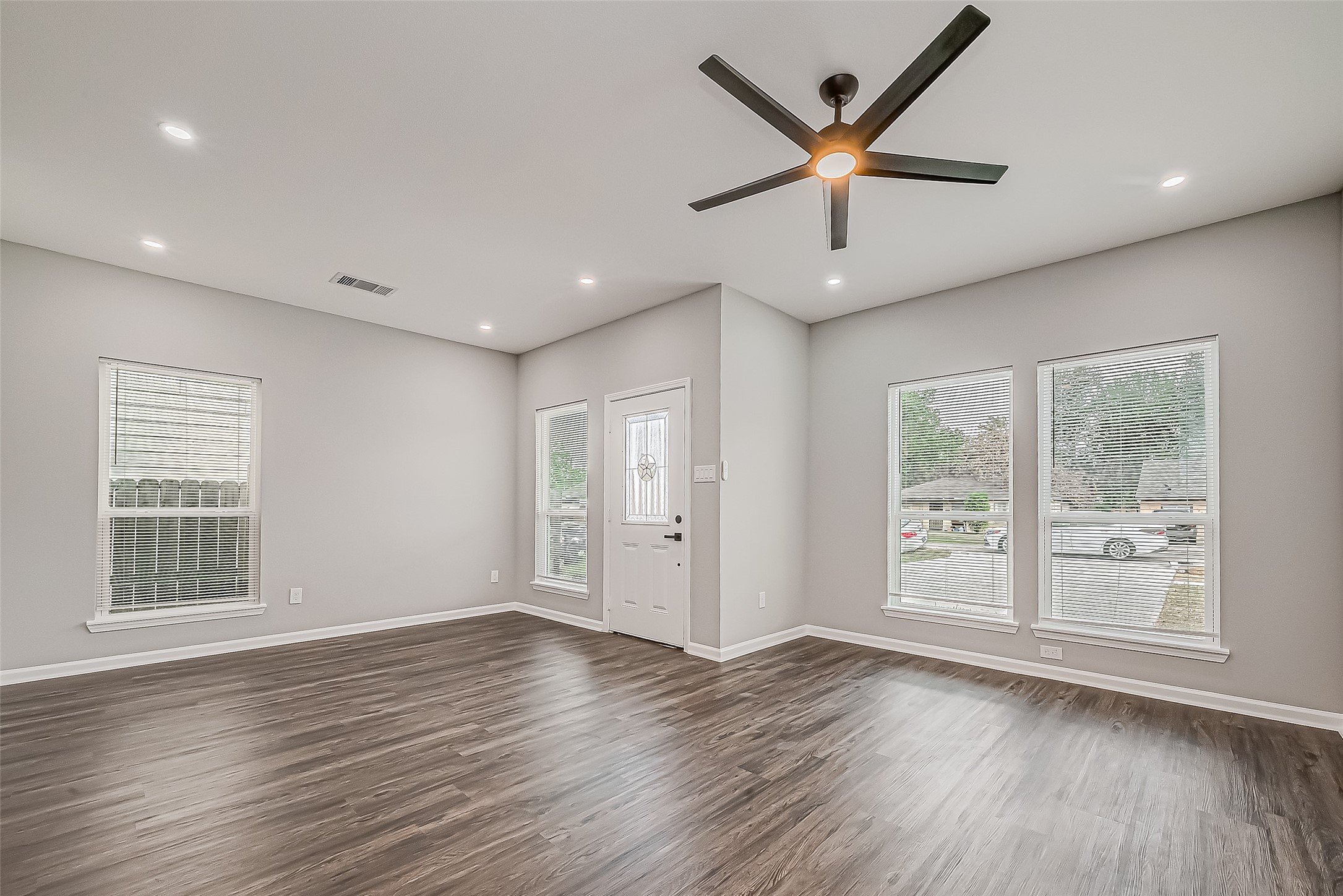 7234 St Augustine Street, Unit A Houston, TX 77021 - Photo 4 of 20 a view of an empty room with window and wooden floor