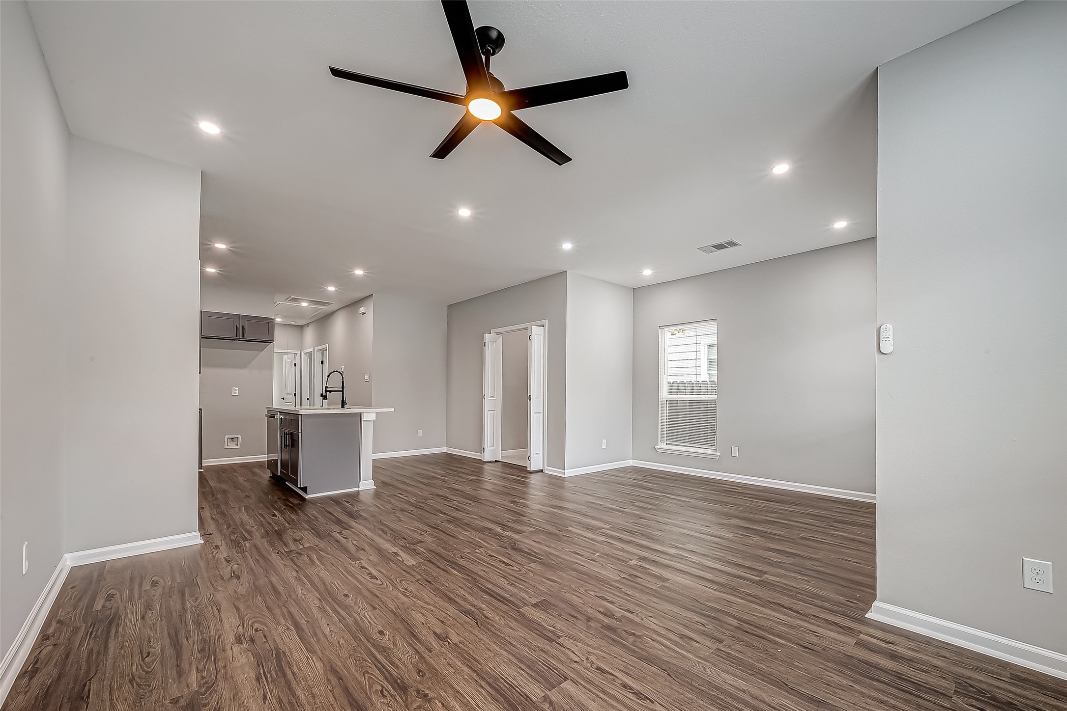7234 St Augustine Street, Unit A Houston, TX 77021 - Photo 5 of 20 a view of an empty room with a window and wooden floor