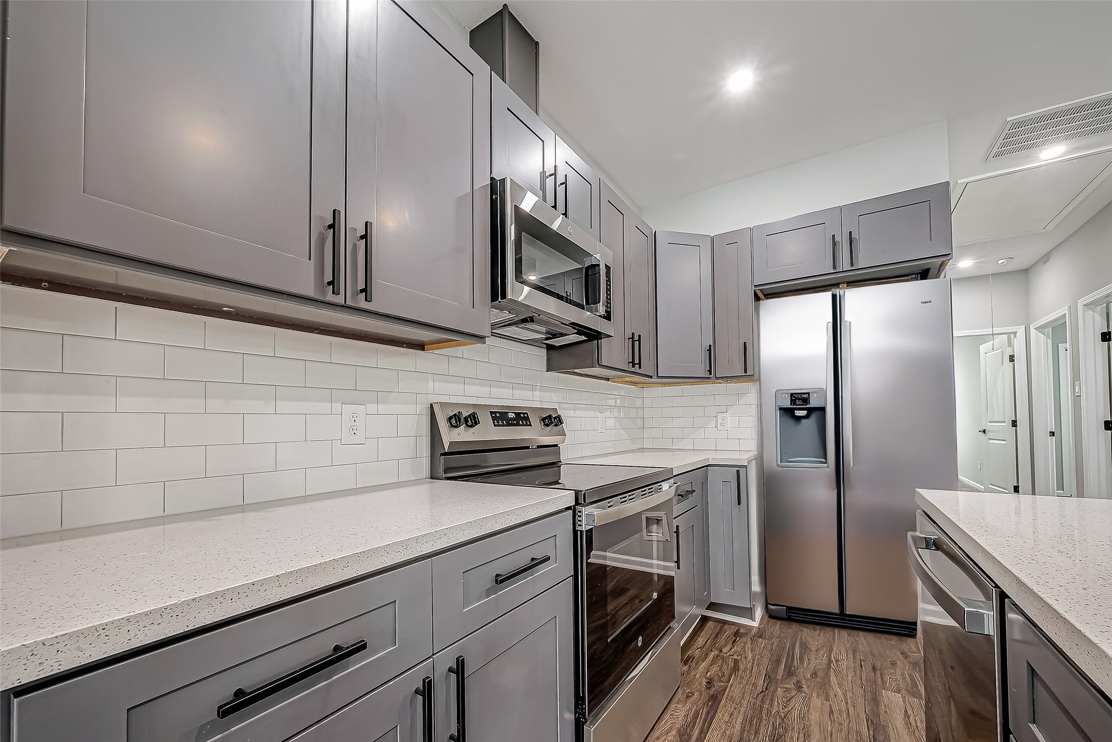 7234 St Augustine Street, Unit A Houston, TX 77021 - Photo 9 of 20 a kitchen with stainless steel appliances a sink cabinets and wooden floor