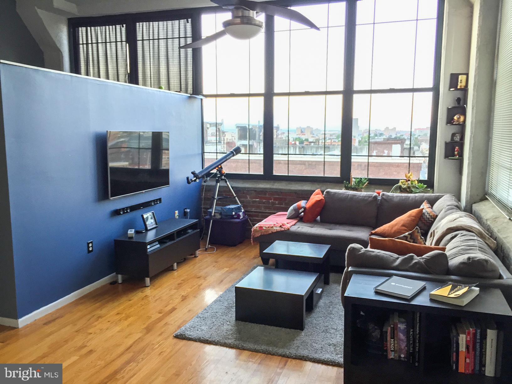 314 North 12th Street, Unit 901 Philadelphia, PA 19107 - Photo 2 of 14 a living room with furniture and a flat screen tv