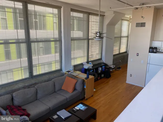 a living room with furniture and a floor to ceiling window