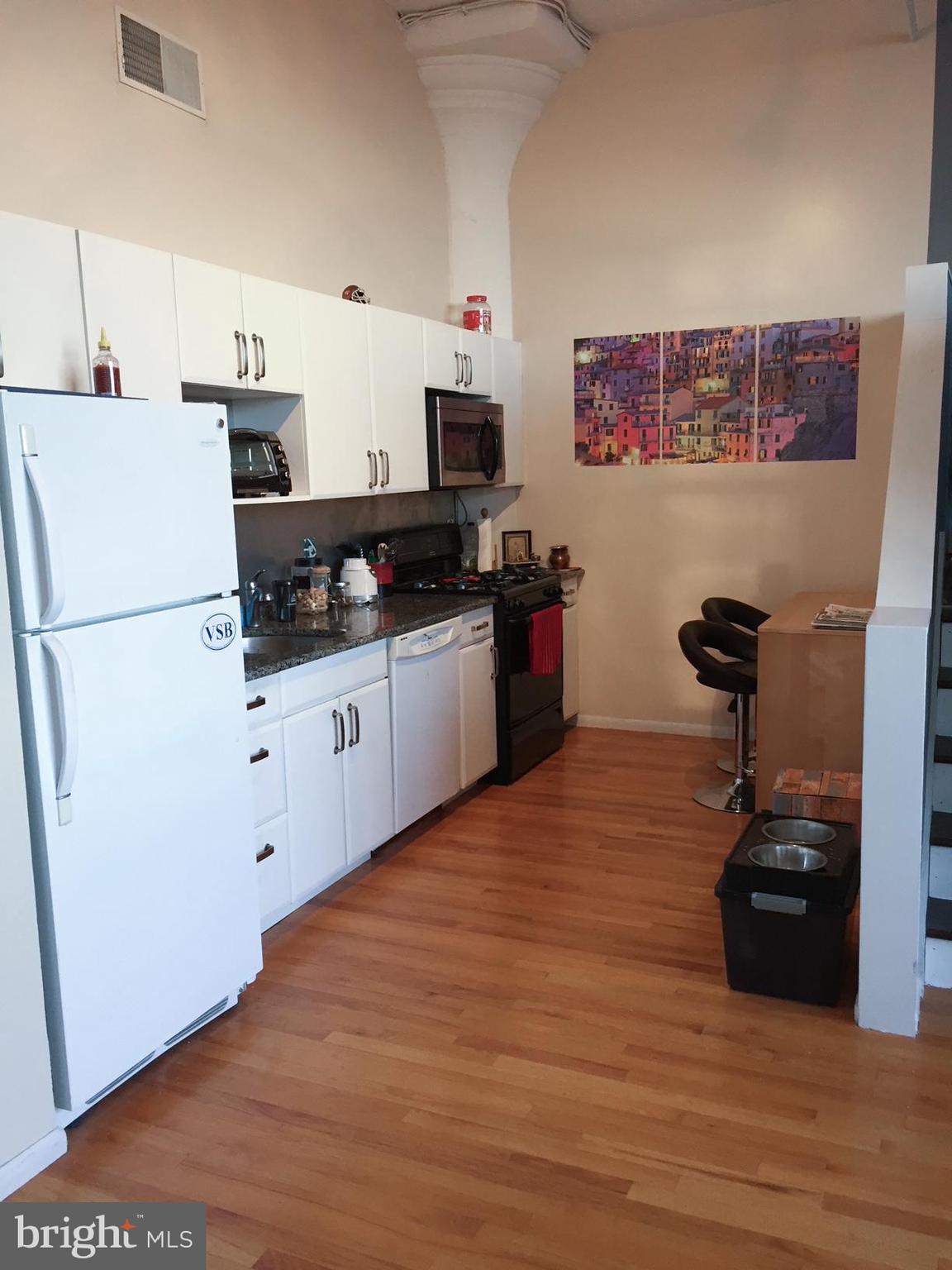 314 North 12th Street, Unit 901 Philadelphia, PA 19107 - Photo 6 of 14 a kitchen with granite countertop a refrigerator a stove top oven a sink and dishwasher