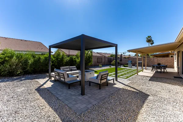 a view of a patio with table and chairs potted plants and swimming pool