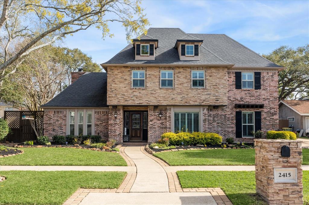 2415 Golfcrest Drive Pearland, TX 77581 - Photo 1 of 32 Updated front elevation with added dormers and stone, all new window world windows with lifetime transferable warranty