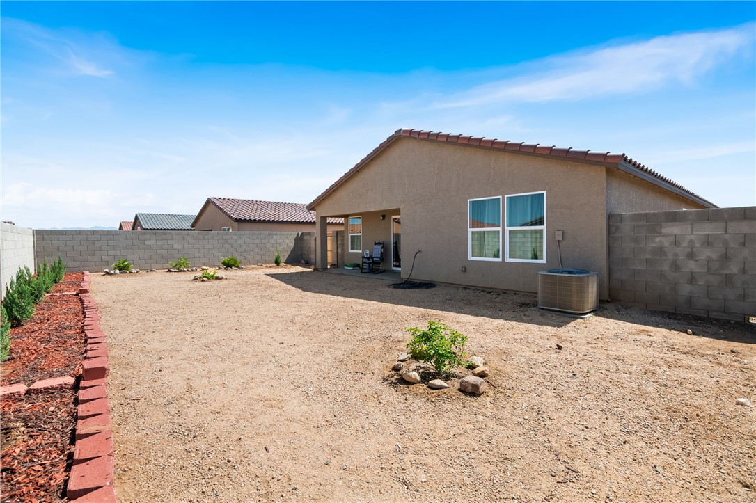 3623 East Andrea Drive Kingman, AZ 86409 - Photo 37 of 40 The property features a spacious backyard with a gravel surface and a brick-lined planter area