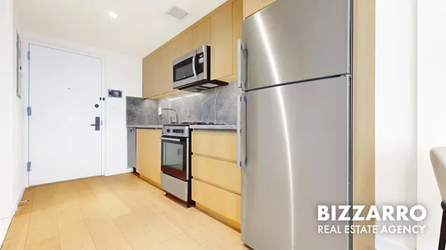 a kitchen with stainless steel appliances granite countertop a refrigerator and a stove