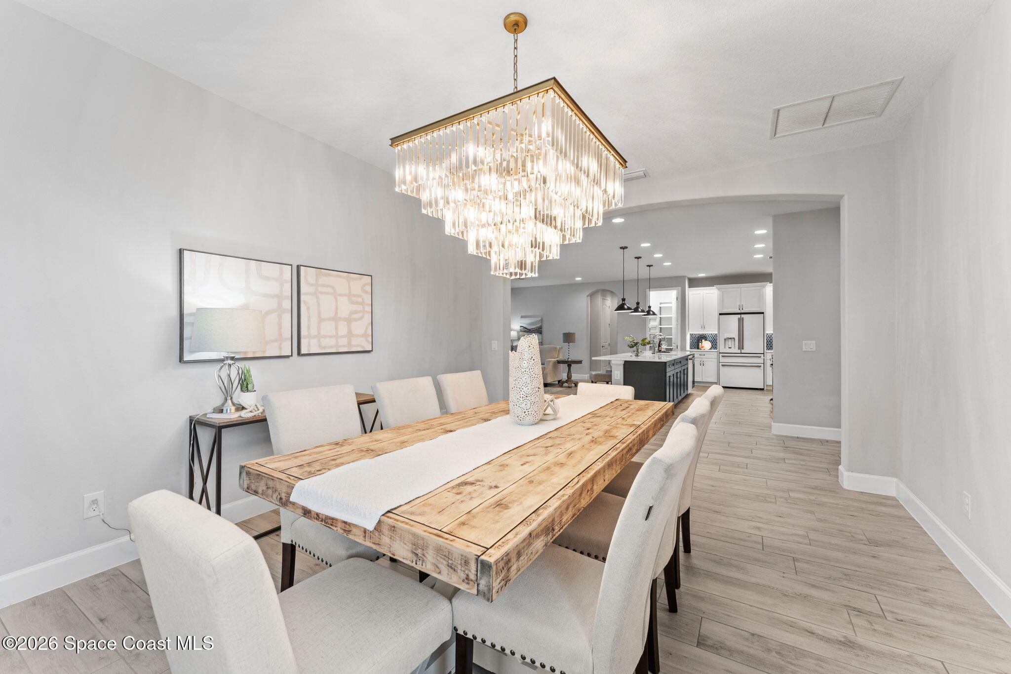 3158 Addison Drive Melbourne, FL 32940 - Photo 12 of 51 a view of a dining room with furniture and chandelier