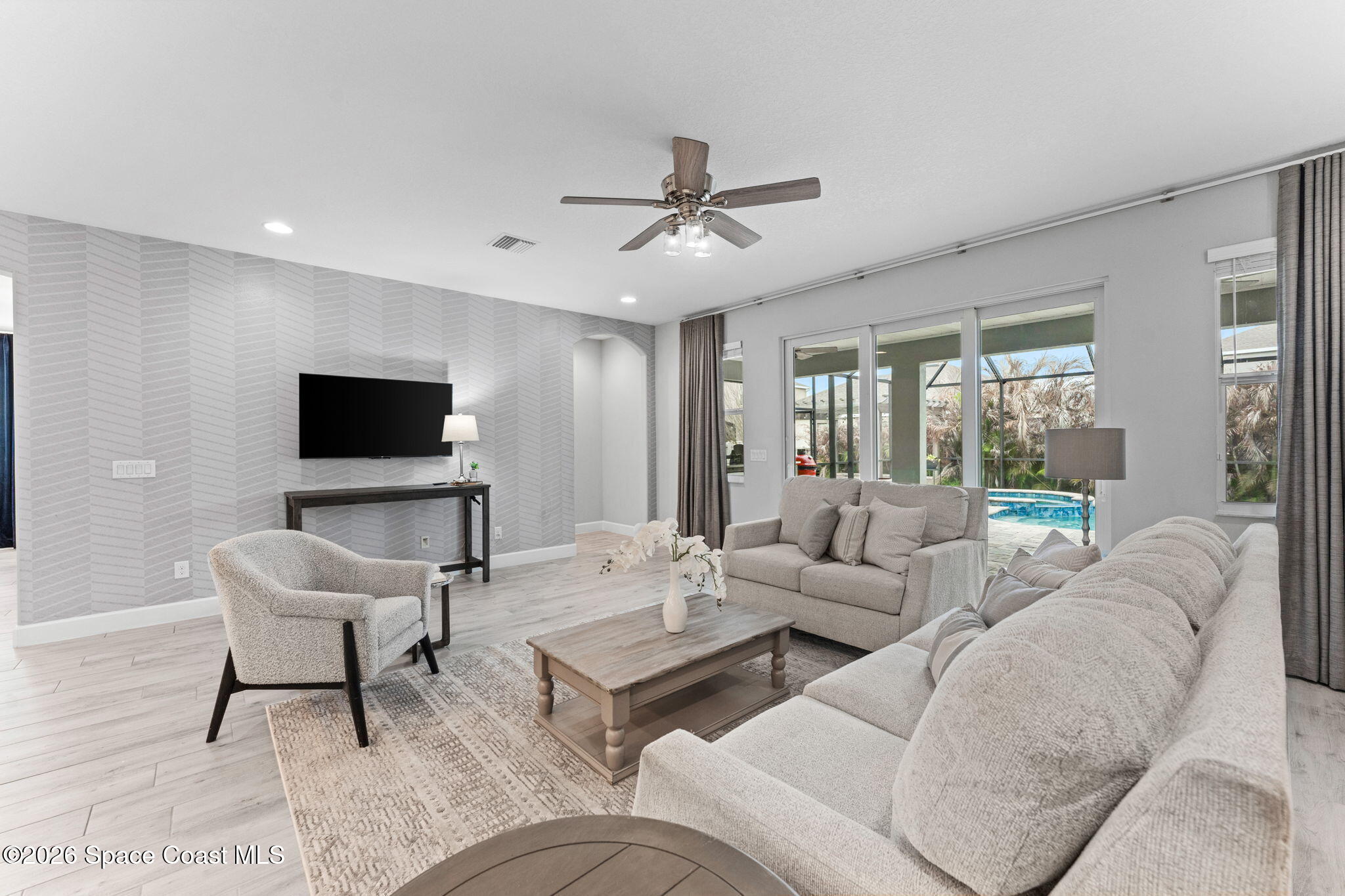 3158 Addison Drive Melbourne, FL 32940 - Photo 17 of 51 a living room with furniture and a flat screen tv