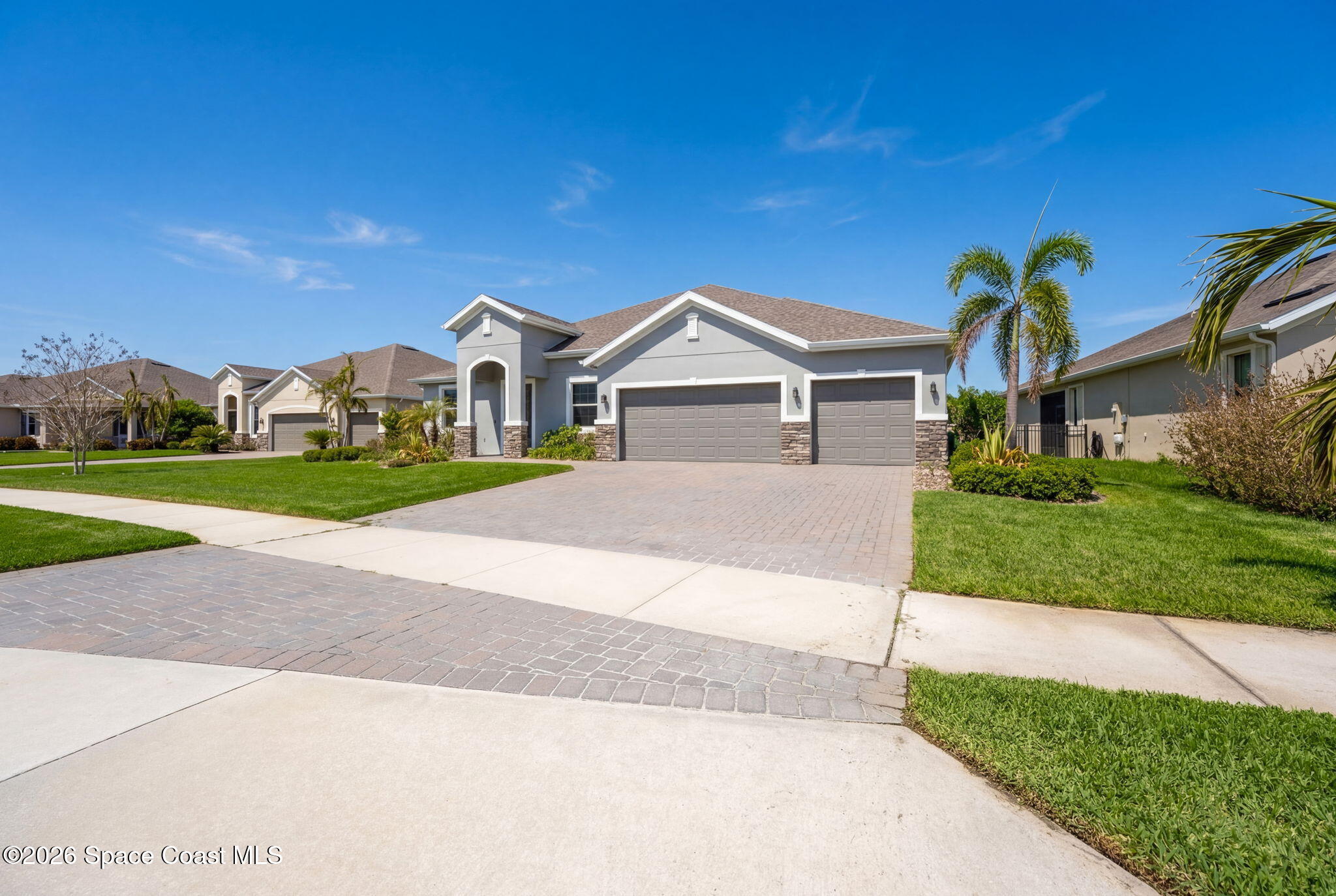 3158 Addison Drive Melbourne, FL 32940 - Photo 2 of 51 a front view of a house with a yard and garage
