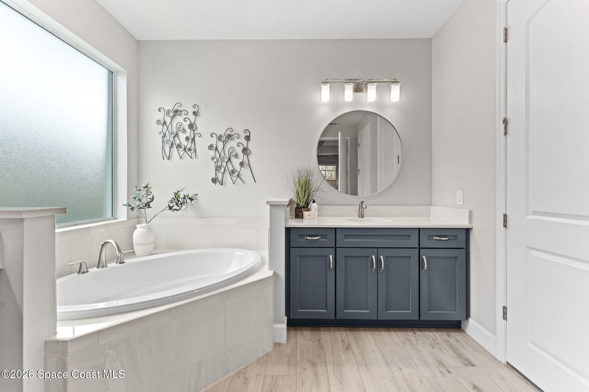 3158 Addison Drive Melbourne, FL 32940 - Photo 22 of 51 a bathroom with a double vanity sink and a mirror